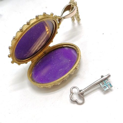 788 - Charles Horner key brooch with enamel detail, antique locket pendant 6cm drop, etc. in a blue fabric... 