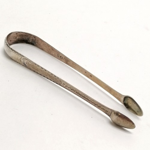 1116 - Antique pair of Newcastle silver sugar tongs with bright cut detail - 14cm & 25g