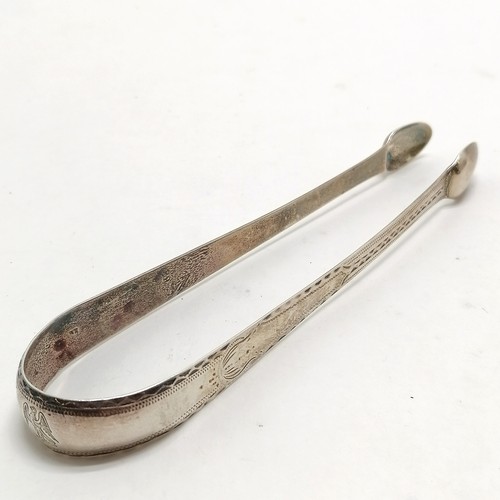 1116 - Antique pair of Newcastle silver sugar tongs with bright cut detail - 14cm & 25g