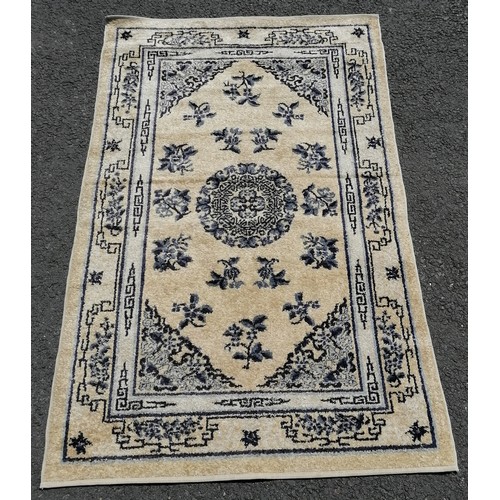 76 - Chinese rug in cream depicting flowers. Measures 153 x 94cm. In very good used condition.