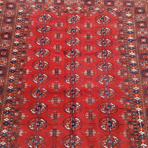 87 - Persian red grounded rug with geometric pattern - 193cm x 125cm & in overall good used condition