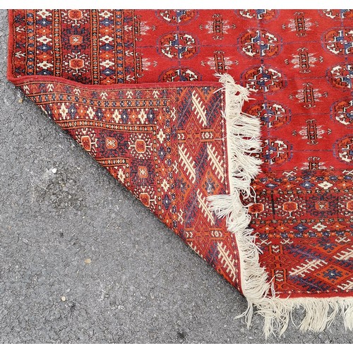 87 - Persian red grounded rug with geometric pattern - 193cm x 125cm & in overall good used condition