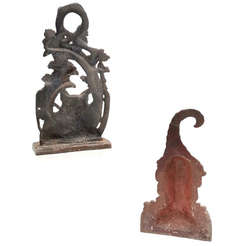 91 - 2 x cast iron doorstops ~ fox hunting related (28cm) & green man (old repair to top of hat)