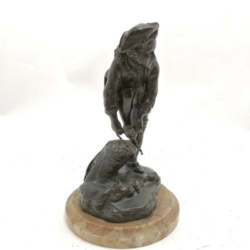 174 - Antique continental bronze figure of a young male tying on an ice skate on a marble base - 19cm high