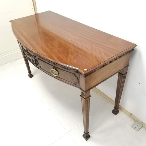 205 - 2 drawer mahogany bow fronted side table with carved urn detail to centre, 136 cm wide, 68 cm deep, ... 