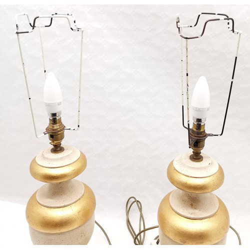 209 - Pair of classical style wooden lamps with gilt detail, 49 cm high, 17 cm wide.