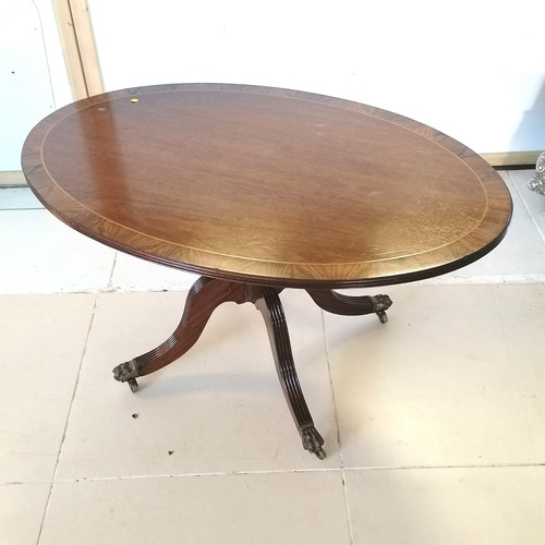 211 - Mahogany oval coffee table on pedestal base with hairy paw feet,101 cm wide, 67 cm deep, 53 cm high.... 