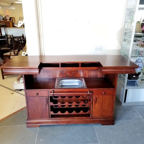 212 - Mahogany panel fronted bar, fitted with stainless steel basin, and a brass foot rail, 63 cm wide, 11... 