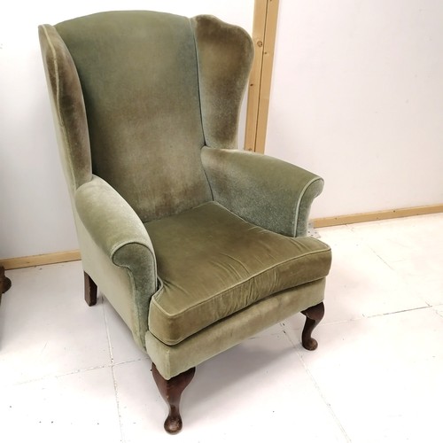 245 - Pair of wing back easy chairs, upholstered in a green plush material, 78 cm  wide, 100 cm high, 70 c... 