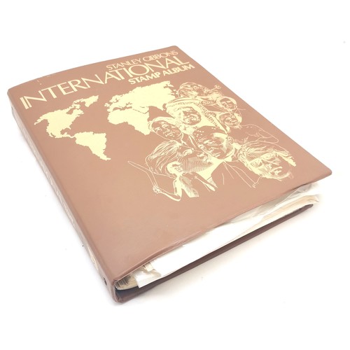 256 - SG International stamp album packed with stamps t/w Strand stamp album (virtually empty)