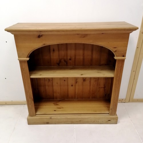 336 - Pine bookcase fitted with 2 adjustable shelves, decorated with reeded column supports on platform ba... 