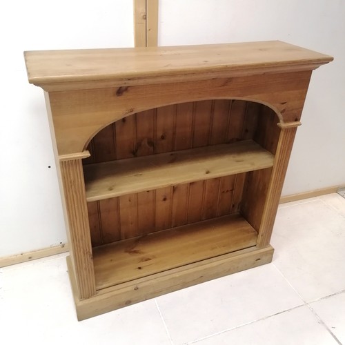 336 - Pine bookcase fitted with 2 adjustable shelves, decorated with reeded column supports on platform ba... 