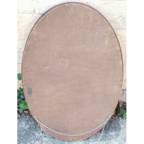 593 - Oak framed oval bevel edge wall mirror,80 cm wide, 55 cm high, frame needs slight attention.