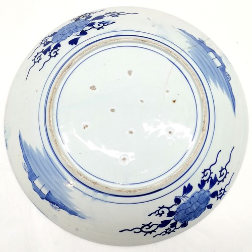 144 - Antique Oriental blue & white wall charger with 9 firing marks to base - 47cm diameter and has 2 hai... 