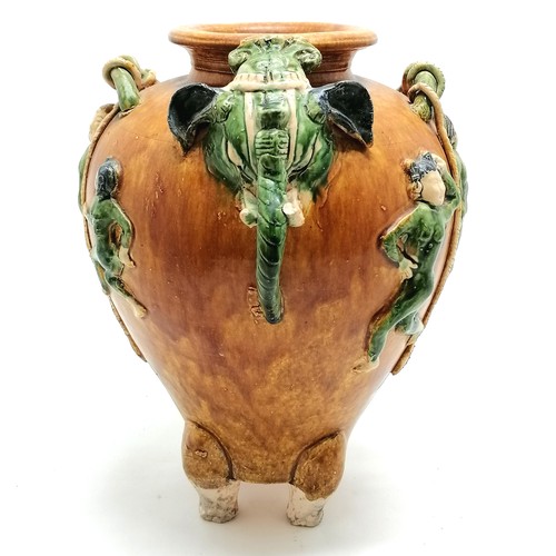 145 - Oriental glazed terracotta pot, with dancing figures and elephant mask head and tail detail, 29 cm h... 