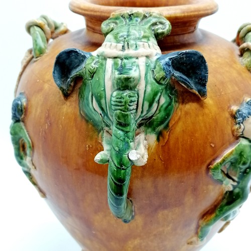 145 - Oriental glazed terracotta pot, with dancing figures and elephant mask head and tail detail, 29 cm h... 