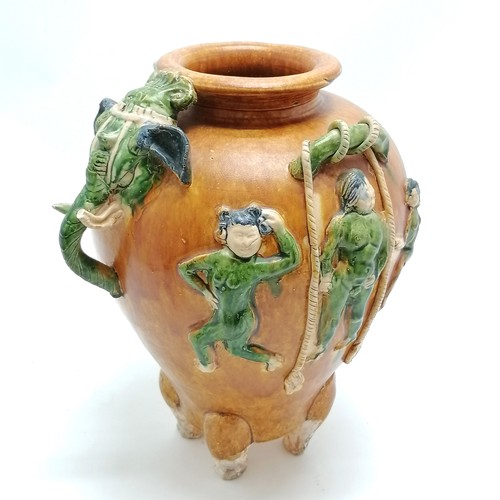 145 - Oriental glazed terracotta pot, with dancing figures and elephant mask head and tail detail, 29 cm h... 