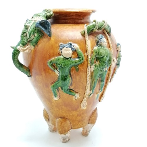 145 - Oriental glazed terracotta pot, with dancing figures and elephant mask head and tail detail, 29 cm h... 