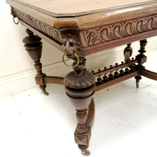 187 - Antique French oak centre table with carved lion mask handles to the corners, with shaped and turned... 