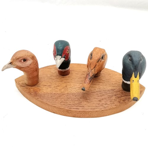 199 - Set of 4 carved walking stick handles mounted on a board, duck, pheasant, grouse and a duck. all in ... 