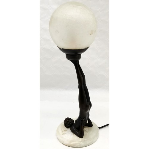 277 - Art Deco style bronzed resin figure of a lady balancing a ball on her feet, on marble base, with cra... 