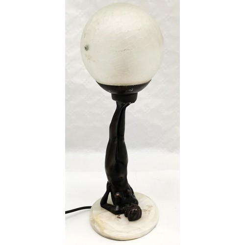 277 - Art Deco style bronzed resin figure of a lady balancing a ball on her feet, on marble base, with cra... 