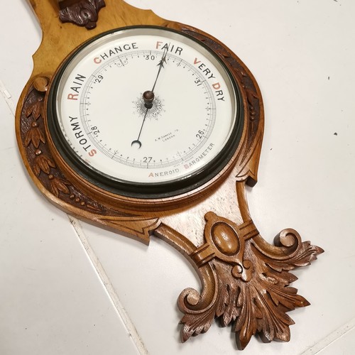 295 - A W Gamage Ltd London, Oak cased, banjo shaped Aneroid barometer, with thermometer, with carved deco... 