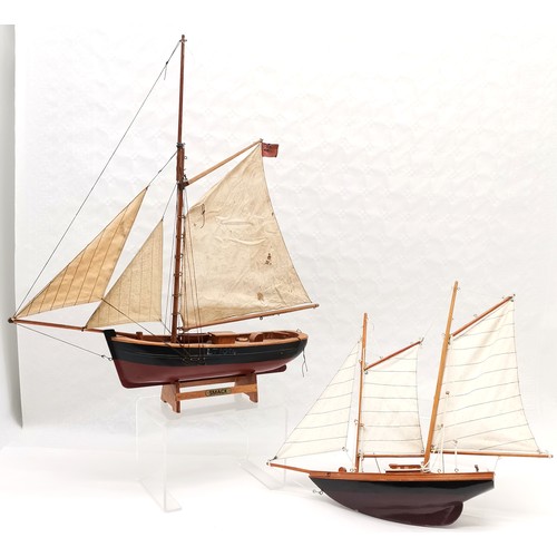 316 - 2 Scratch built wooden model sailboats. 61cm high. name plate smack. Has one sail detached but prese... 