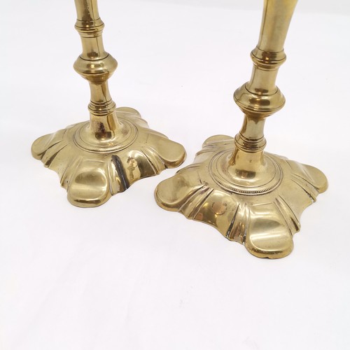 318 - A pair of brass candlesticks in the Georgian style. 25cm high, in used condition both with old repai... 