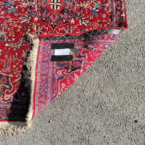 345 - Red ground with all over pattern rug with long fringe, 110 cm wide, 175 cm length, in good condition... 