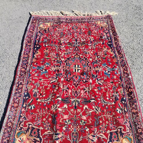 345 - Red ground with all over pattern rug with long fringe, 110 cm wide, 175 cm length, in good condition... 