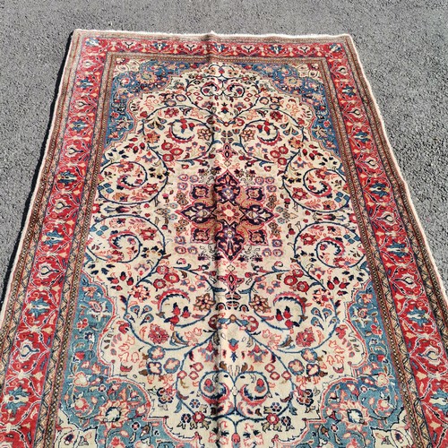 347 - Cream ground rug with central medallion, within red border, 135 cm wide, 210 cm length, in good cond... 