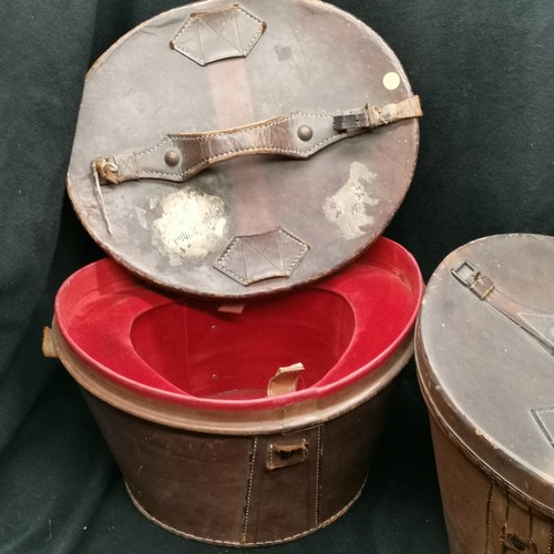 109 - 2 Victorian leather hat boxes t/w 2 silk top hats, one Christies and the other UCL, in good conditio... 