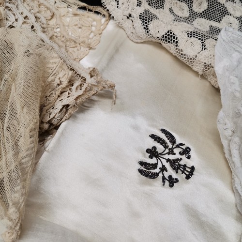 115 - A lot of lace and fabric trims to include satin embroidered with silver thread and red trim