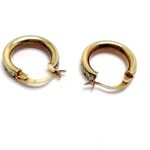 534 - 9ct marked gold hoop earrings channel set with white stones - 2.6g total weight