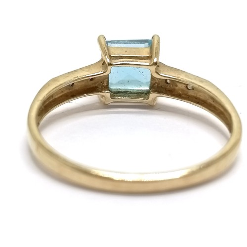 575 - 9ct hallmarked gold blue topaz ring with diamond set shoulders - size Q½ & 2.1g total weight