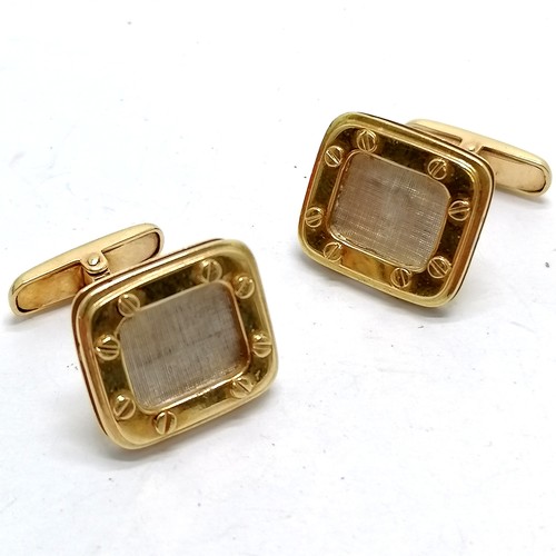 577 - 18ct marked gold cufflinks with white gold centres surrounded with screwed frame - 12.8g total