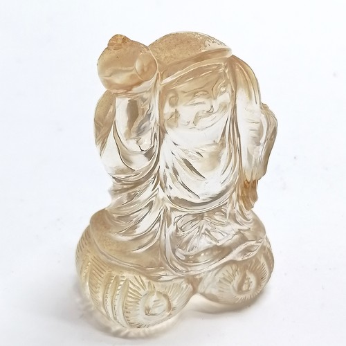 43 - Oriental carved rock crystal figure of a man carrying a sack on a wooden base - total height 8.5cm a... 