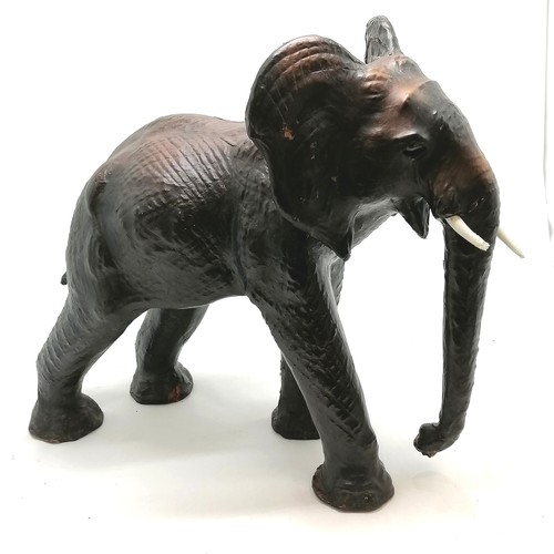 66 - Unusual leather elephant figure - 58cm high x 62cm across ~ signs of wear and both tusks slight a/f