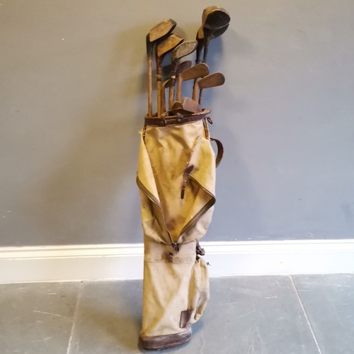 141 - Set of Vintage golf clubs to include a Excelsior Putter etc, contained in canvas and leather mounted... 