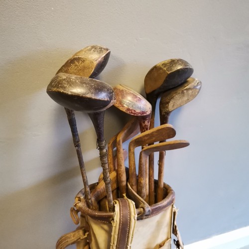 141 - Set of Vintage golf clubs to include a Excelsior Putter etc, contained in canvas and leather mounted... 