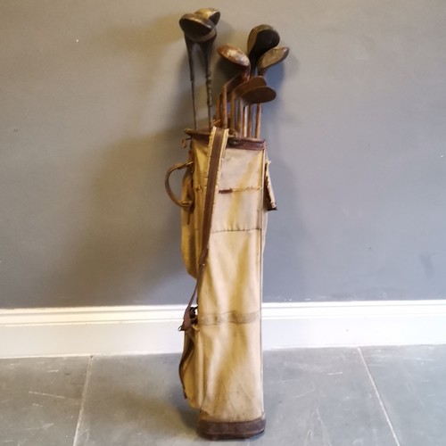 141 - Set of Vintage golf clubs to include a Excelsior Putter etc, contained in canvas and leather mounted... 