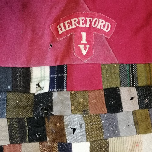 176 - WWI wool patchwork cover with Hereford uniform badges and other badges. In mostly good condition, so... 