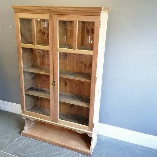 183 - Antique stripped pine double glazed door cabinet, with open shelf to base, 105 cm wide, 31 cm deep, ... 