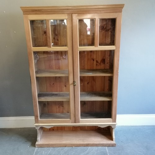 183 - Antique stripped pine double glazed door cabinet, with open shelf to base, 105 cm wide, 31 cm deep, ... 