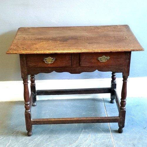 198 - Antique oak 2 drawer side table, with brass drop handles, turned column supports, marks to the top b... 