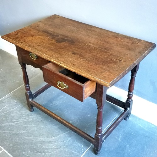 198 - Antique oak 2 drawer side table, with brass drop handles, turned column supports, marks to the top b... 