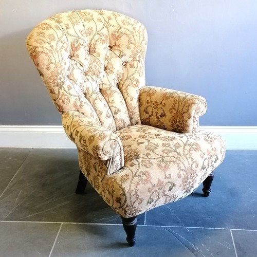 201 - Victorian style button back armchair upholstered in a floral tapestry beige coloured material, in go... 