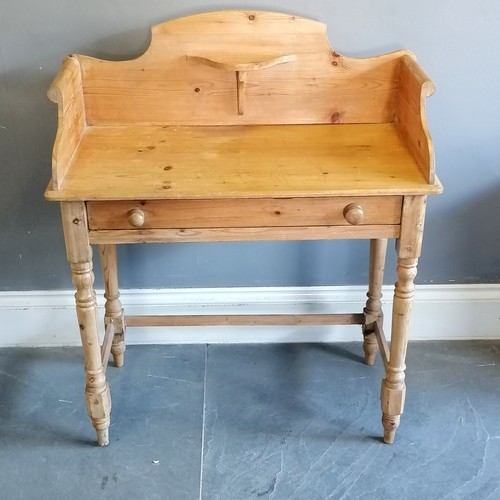 203 - Antique pine washstand with shaped gallery rail, single frieze drawer on turned column supports, in ... 