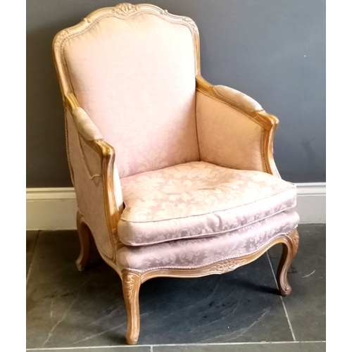 214 - French style salon chair, limed oak frame with carved decoration, upholstered in a pink damask, in u... 